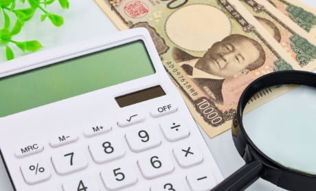 計算機とお金が並べられた奨学金制度のイメージ画像